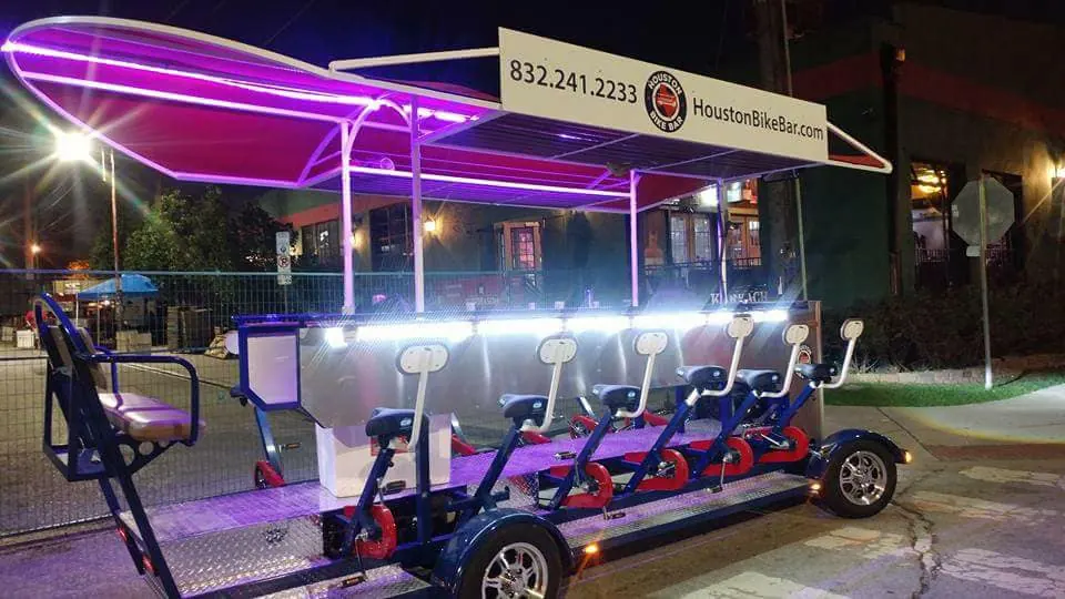 The bike bar's LED-lit canopy at night