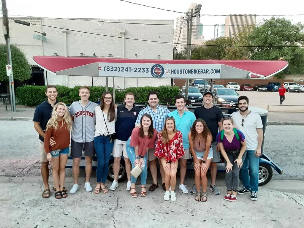 A large group beside the bike bar on a summer afternoon