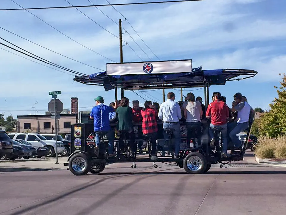 Riders pedaling the Houston Bike Bar down a Houston street