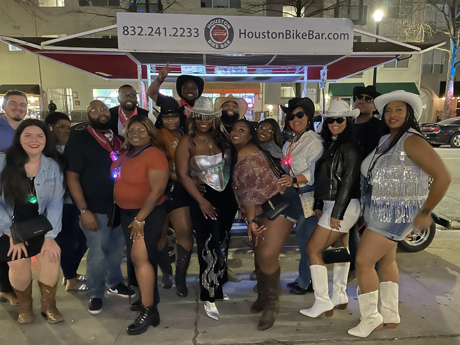 A birthday group in tropical outfits riding the Houston Bike Bar